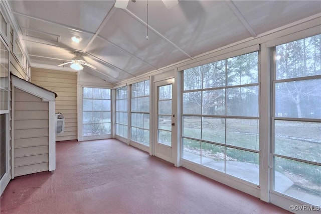 unfurnished sunroom featuring lofted ceiling, ceiling fan, and a healthy amount of sunlight