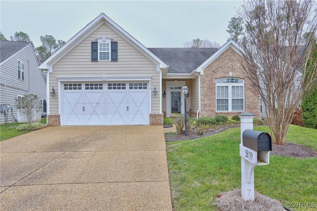 view of front of house with a front lawn and a garage