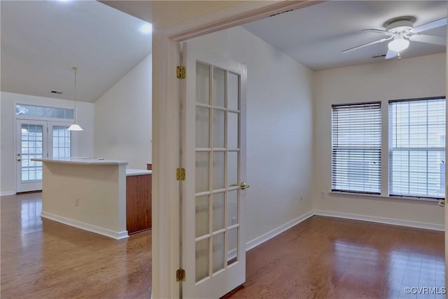 empty room featuring hardwood / wood-style floors, ceiling fan, and french doors