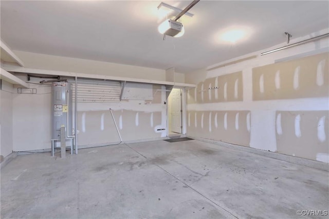 garage featuring electric water heater and a garage door opener