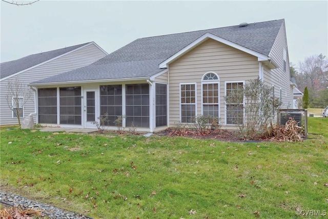 back of house featuring a sunroom and a yard