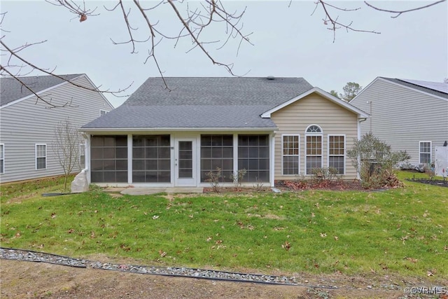 back of house with a lawn and a sunroom