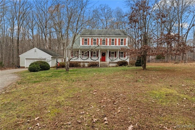 view of front facade featuring an outbuilding, a porch, a garage, and a front yard