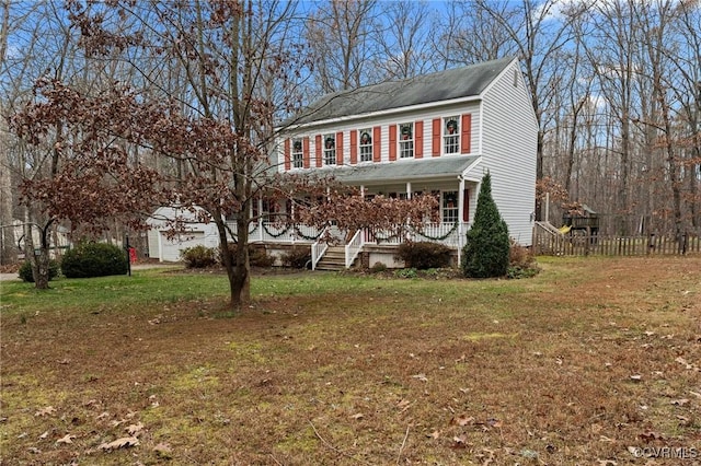 colonial home featuring covered porch and a front lawn