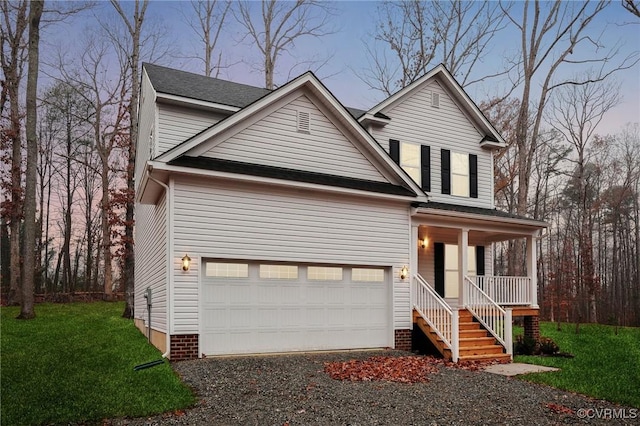 front facade with a lawn, covered porch, and a garage