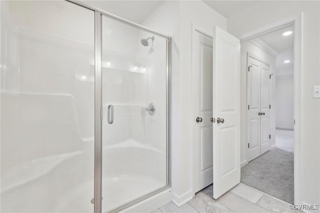 bathroom with a shower with door