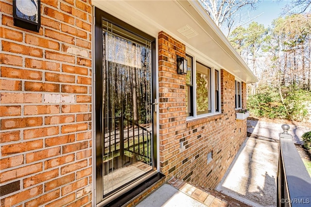 property entrance featuring brick siding