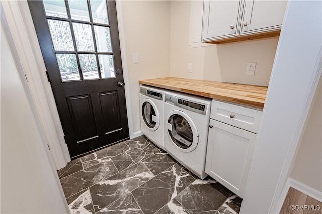 washroom featuring baseboards, cabinet space, marble finish floor, and washing machine and dryer