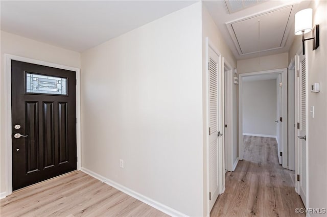 entryway with light wood-type flooring, visible vents, and baseboards