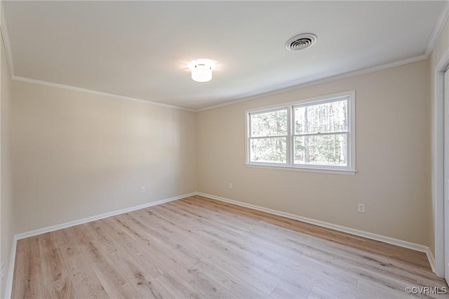 empty room featuring visible vents, baseboards, light wood-style floors, and ornamental molding