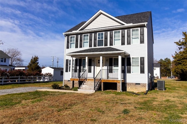 colonial house featuring a front yard, a porch, and central air condition unit