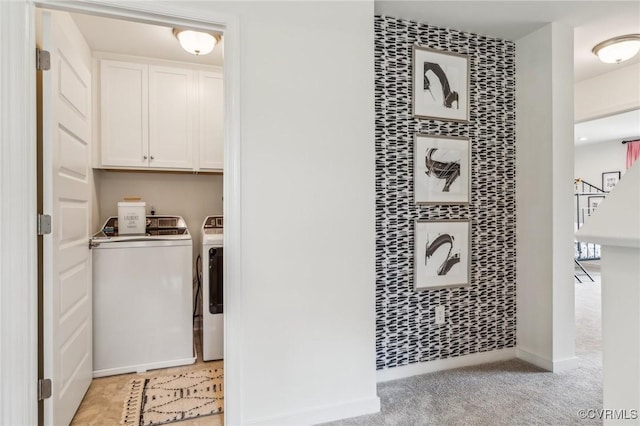 laundry area featuring washer and clothes dryer and light colored carpet