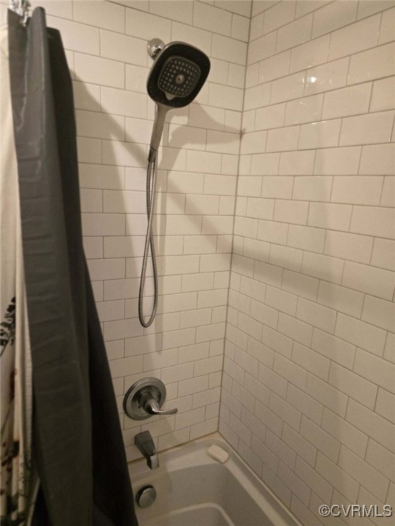 bathroom with shower / bathtub combination with curtain