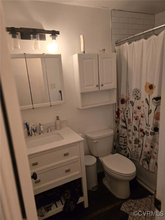 bathroom featuring vanity, toilet, and curtained shower