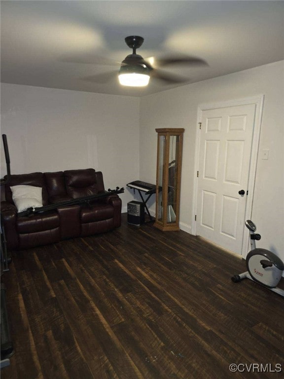 living room featuring dark hardwood / wood-style floors and ceiling fan