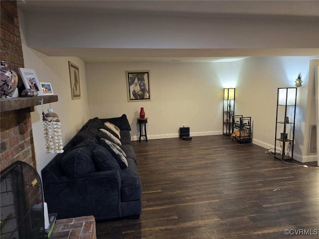 living room featuring dark wood-type flooring and a fireplace