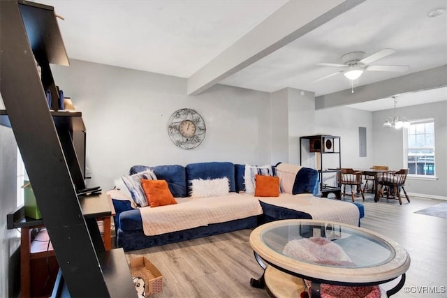 living room featuring wood-type flooring, ceiling fan with notable chandelier, and beam ceiling