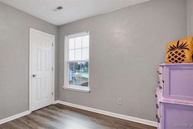 unfurnished bedroom with hardwood / wood-style floors