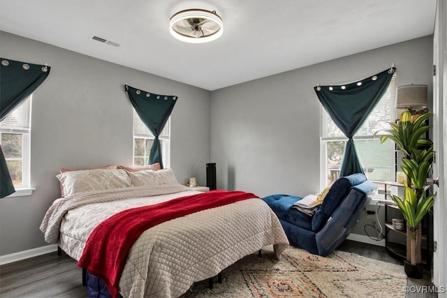 bedroom with dark wood-type flooring