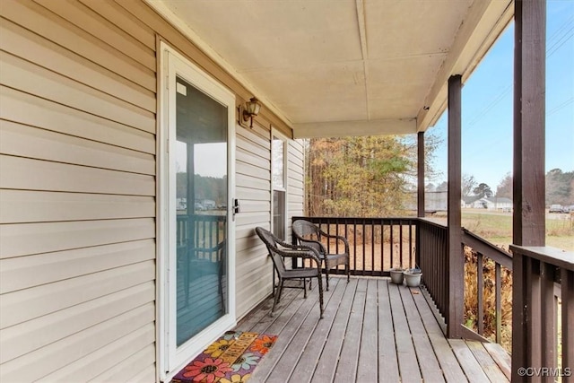 wooden terrace featuring covered porch