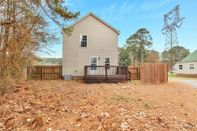 rear view of property with central AC unit and a wooden deck