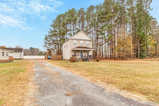 view of front property with covered porch and a front lawn