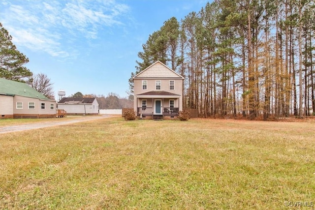 view of property with covered porch and a front yard