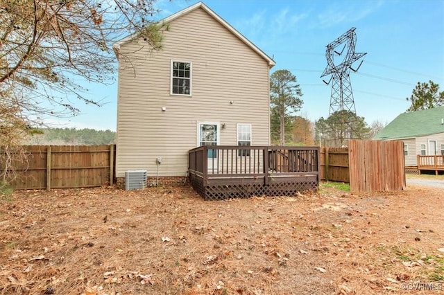 back of property with a wooden deck and central AC unit