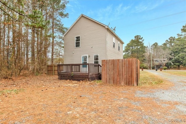 back of property featuring a wooden deck