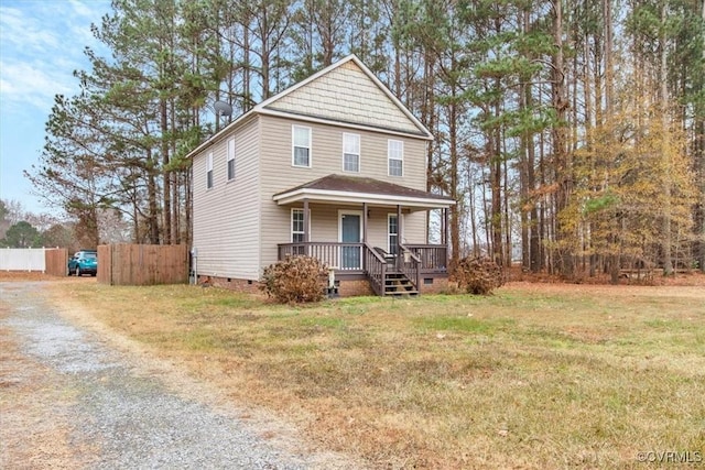 view of property with covered porch and a front yard