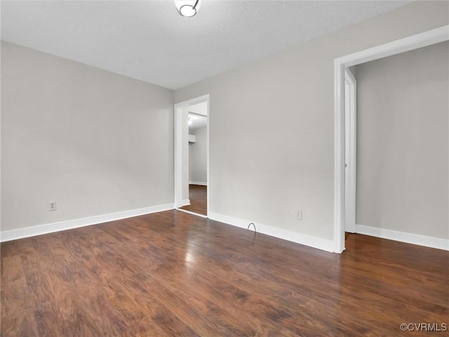 unfurnished bedroom with dark hardwood / wood-style floors and a textured ceiling