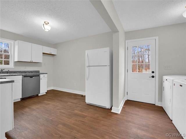 kitchen with dishwasher, white refrigerator, white cabinetry, and washer and clothes dryer