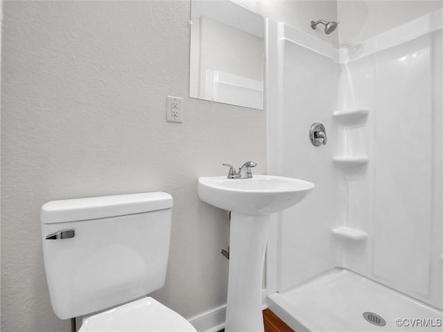 bathroom with a shower and toilet