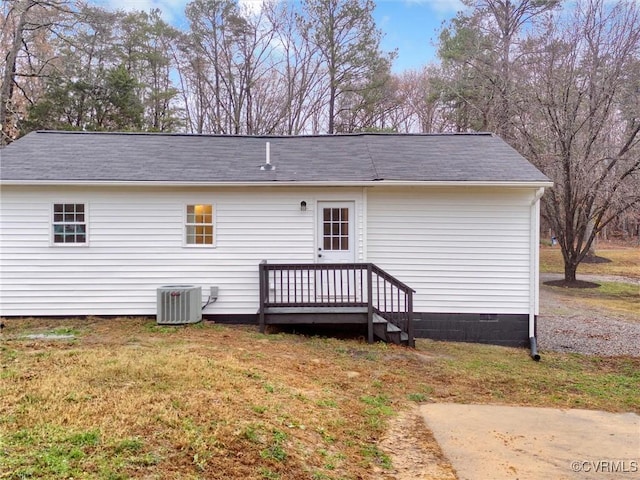 back of house featuring a yard and cooling unit