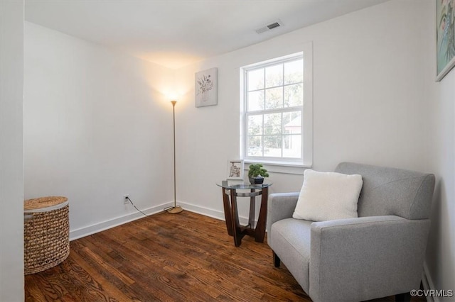 sitting room with dark wood-type flooring