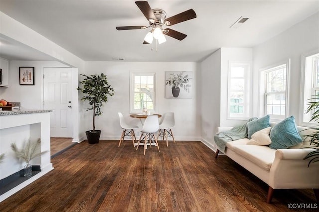 dining space featuring ceiling fan and dark hardwood / wood-style flooring