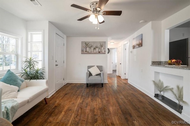 sitting room featuring ceiling fan and dark hardwood / wood-style flooring