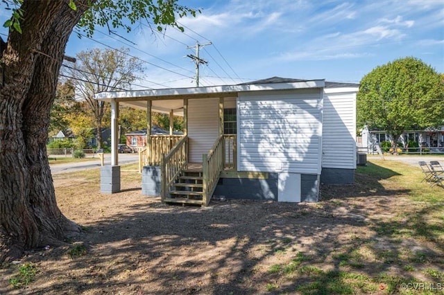 rear view of property with covered porch