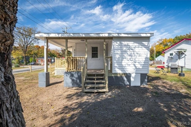 back of house featuring a porch