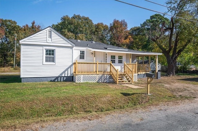 view of front of home with a front yard and covered porch