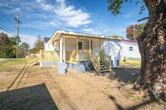 exterior space featuring a porch and a front lawn