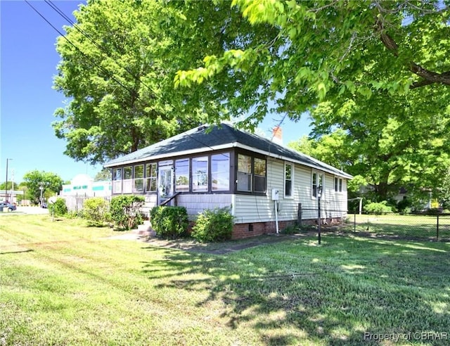 view of front facade with a front lawn and a sunroom