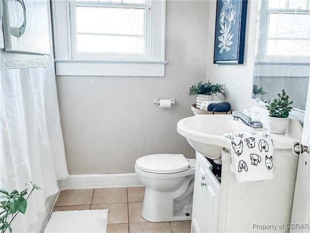 bathroom featuring toilet, vanity, and tile patterned floors