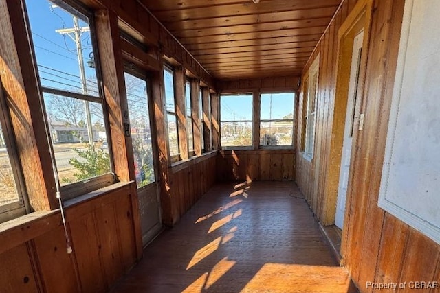 unfurnished sunroom with wooden ceiling