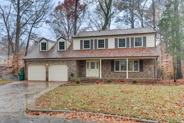 view of front facade with a front yard and a garage