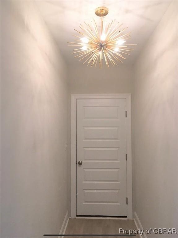 doorway to outside featuring a chandelier