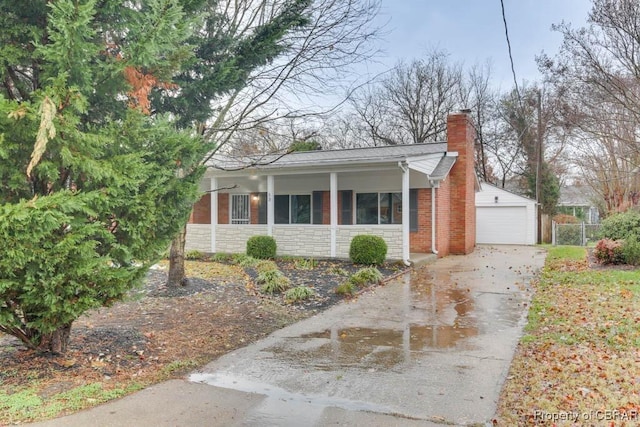 bungalow with an outdoor structure and a garage