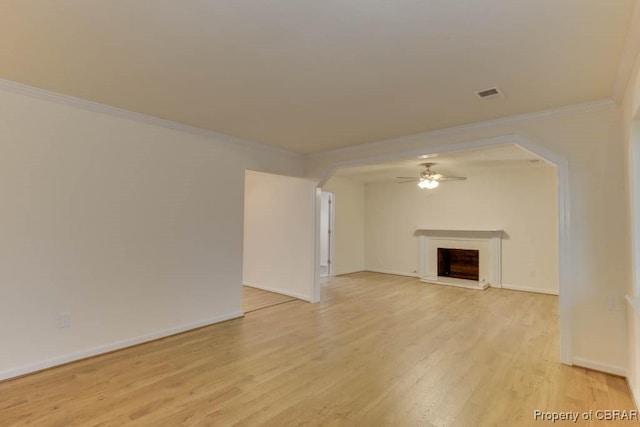 unfurnished living room with ceiling fan, light hardwood / wood-style floors, and ornamental molding