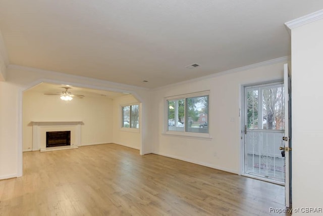 unfurnished living room featuring ceiling fan, crown molding, and light hardwood / wood-style flooring