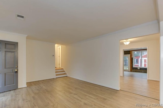 unfurnished room with light wood-type flooring and ornamental molding